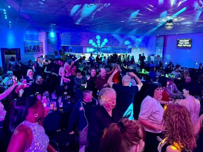 Guests enjoying the dance floor at a lively function