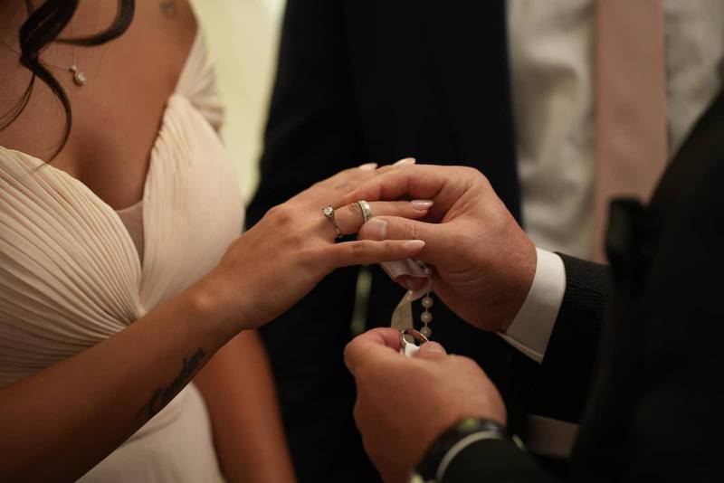 Close-up of a bride and groom exchanging wedding rings during their ceremony