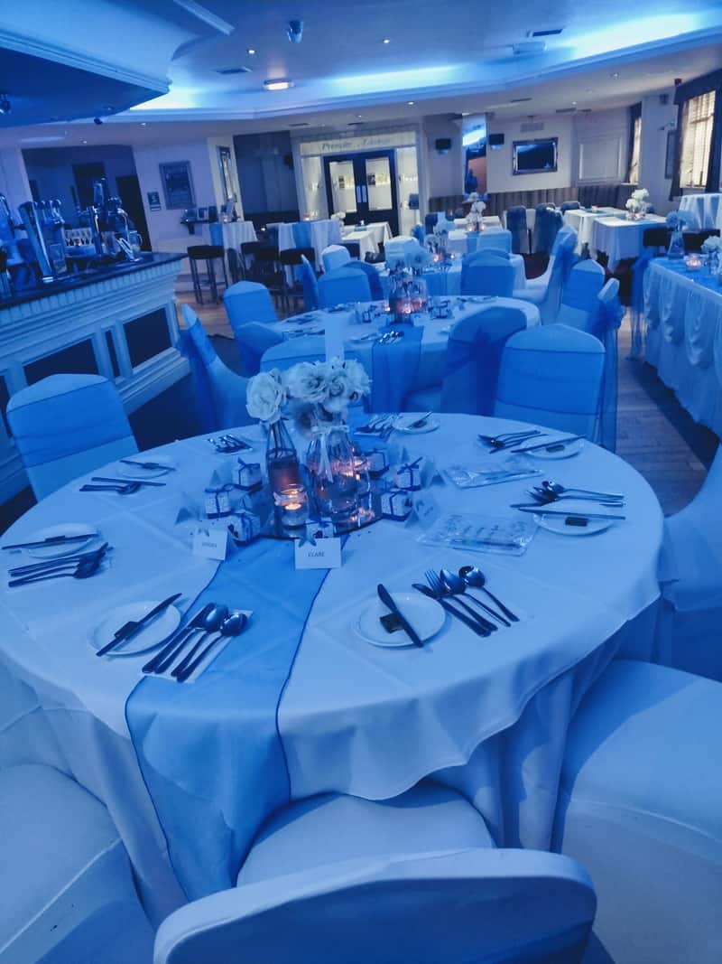Premier Lounge wedding reception setup with elegantly decorated tables, floral centrepieces and warm ambient lighting